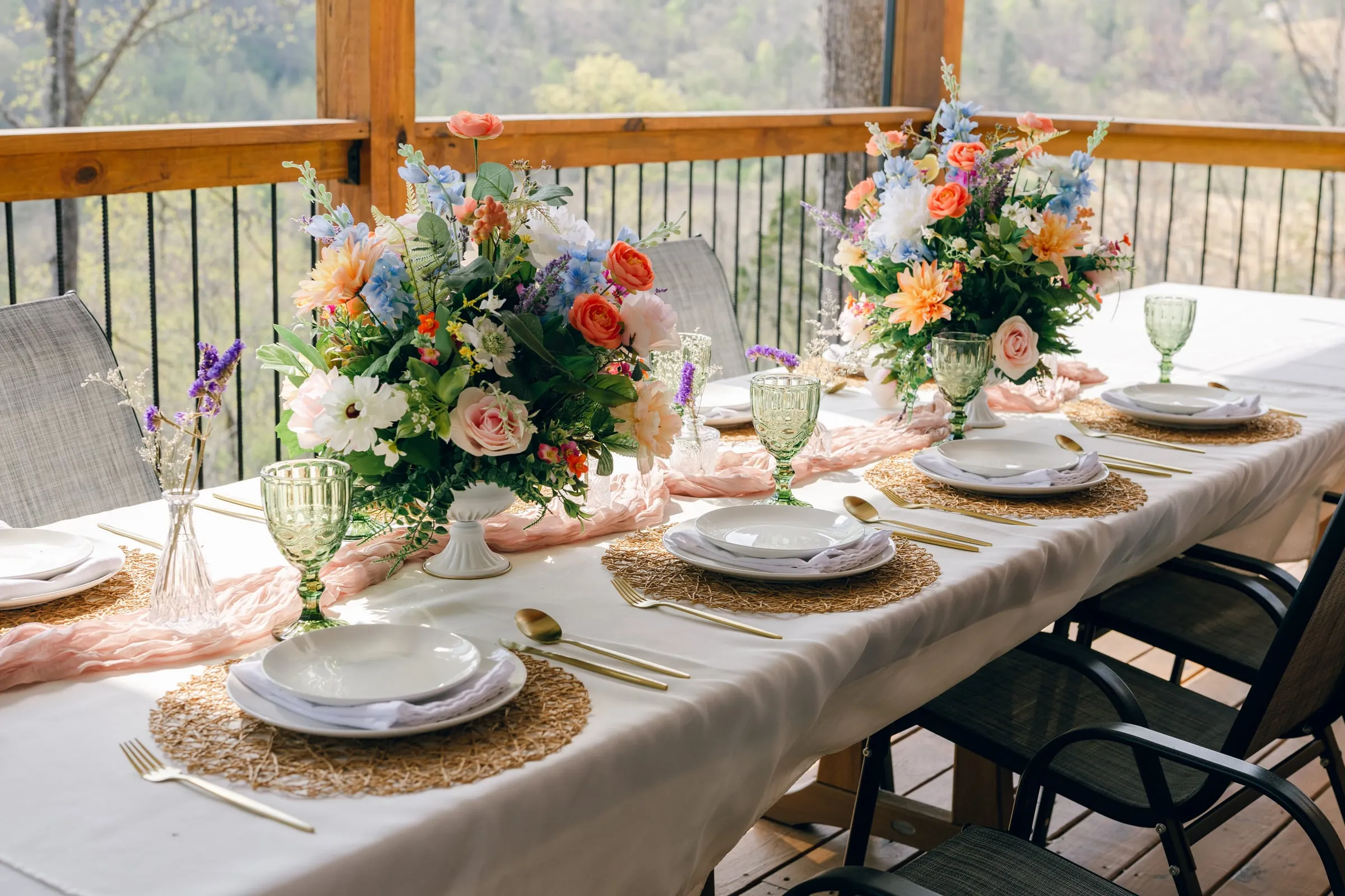 Reception table on the deck with a sweeping mountain and river view