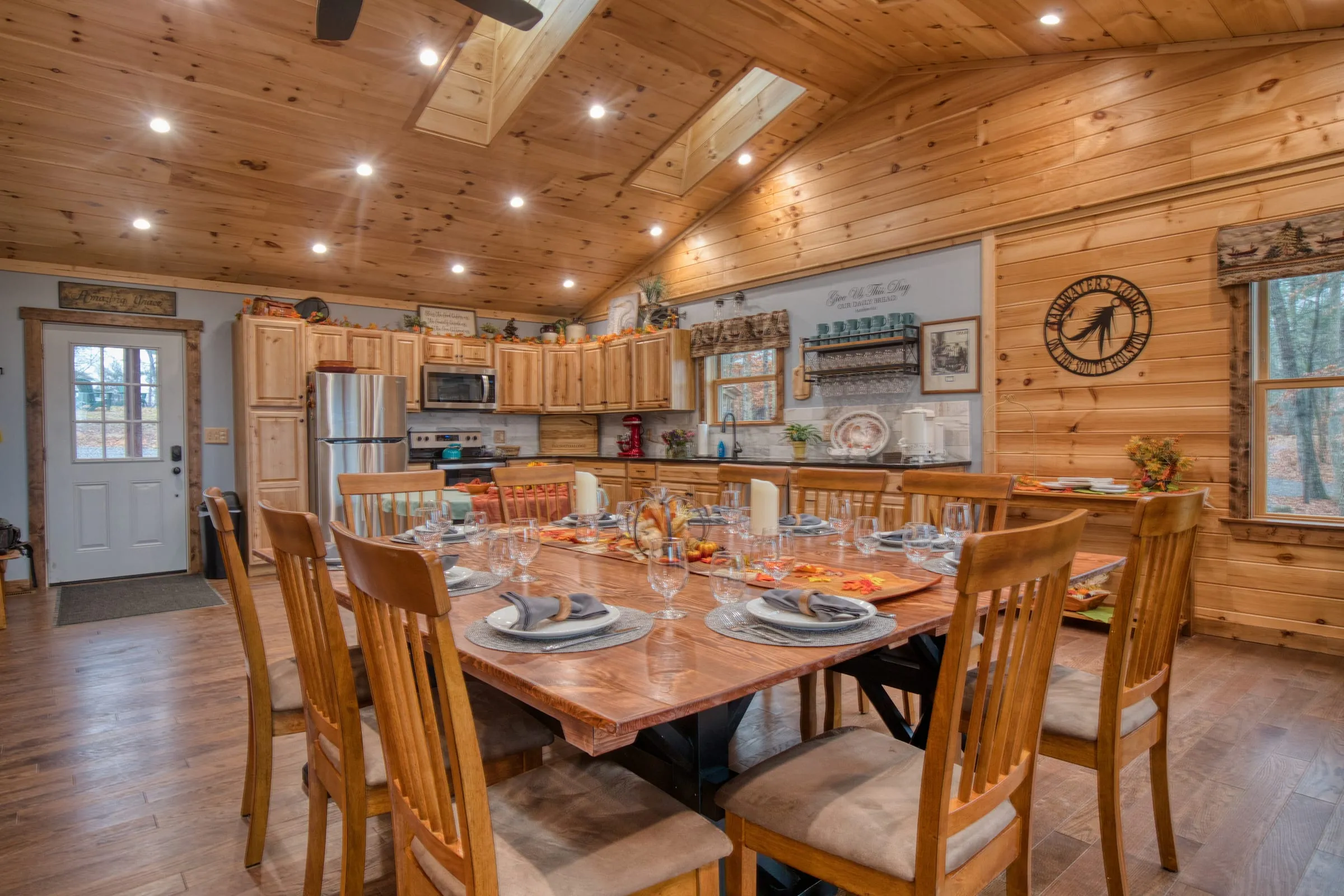 Lodge interior with a long wooden table set for a reception dinner