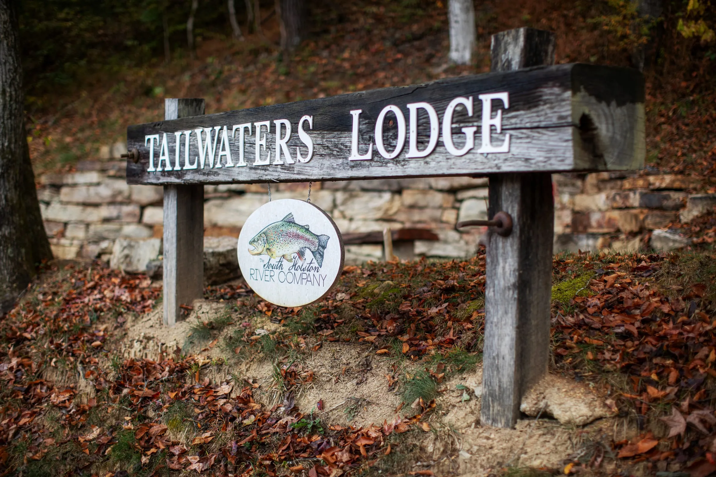 The Tailwaters Lodge entrance sign amid autumn leaves