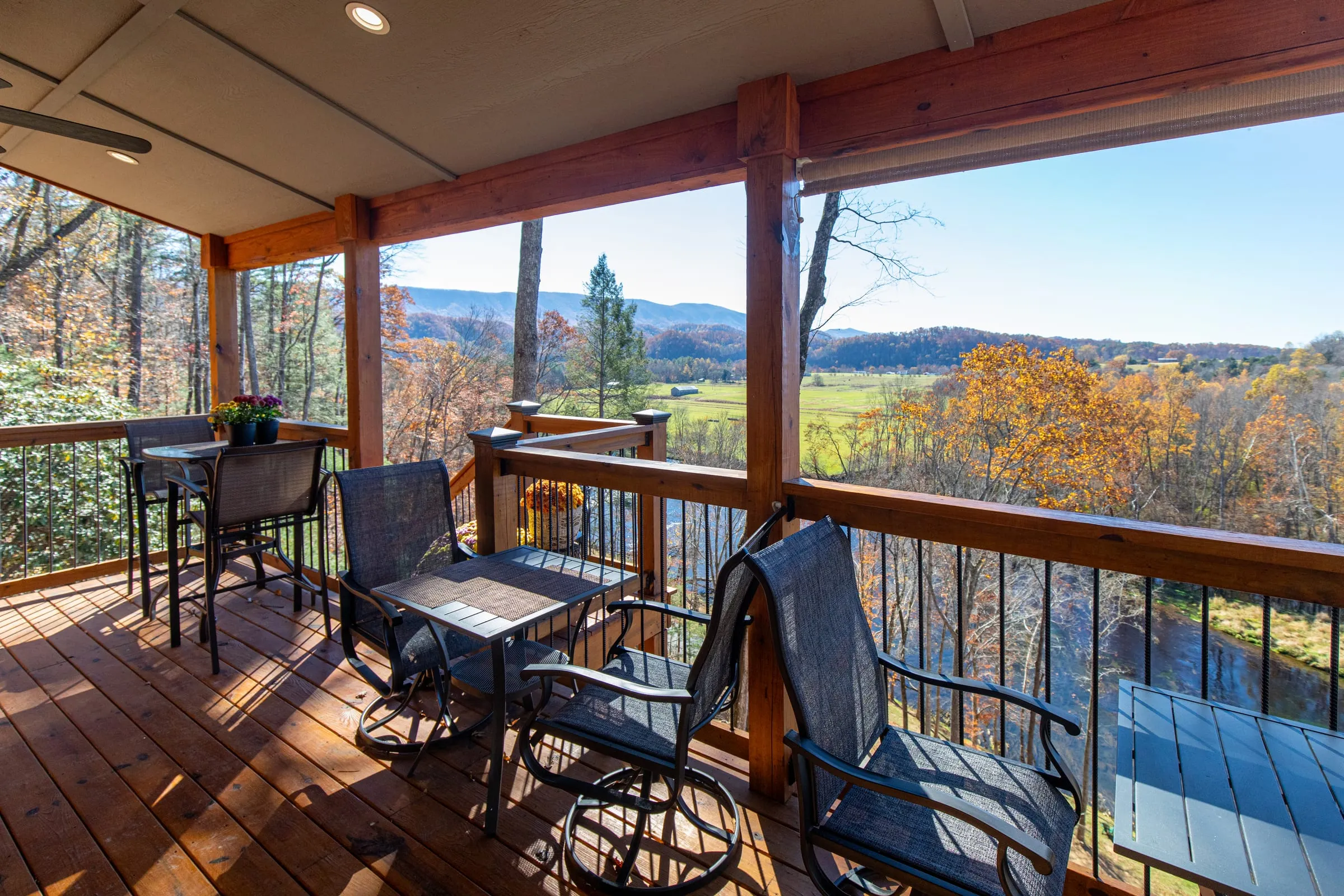 Covered deck seating overlooking the river valley in autumn