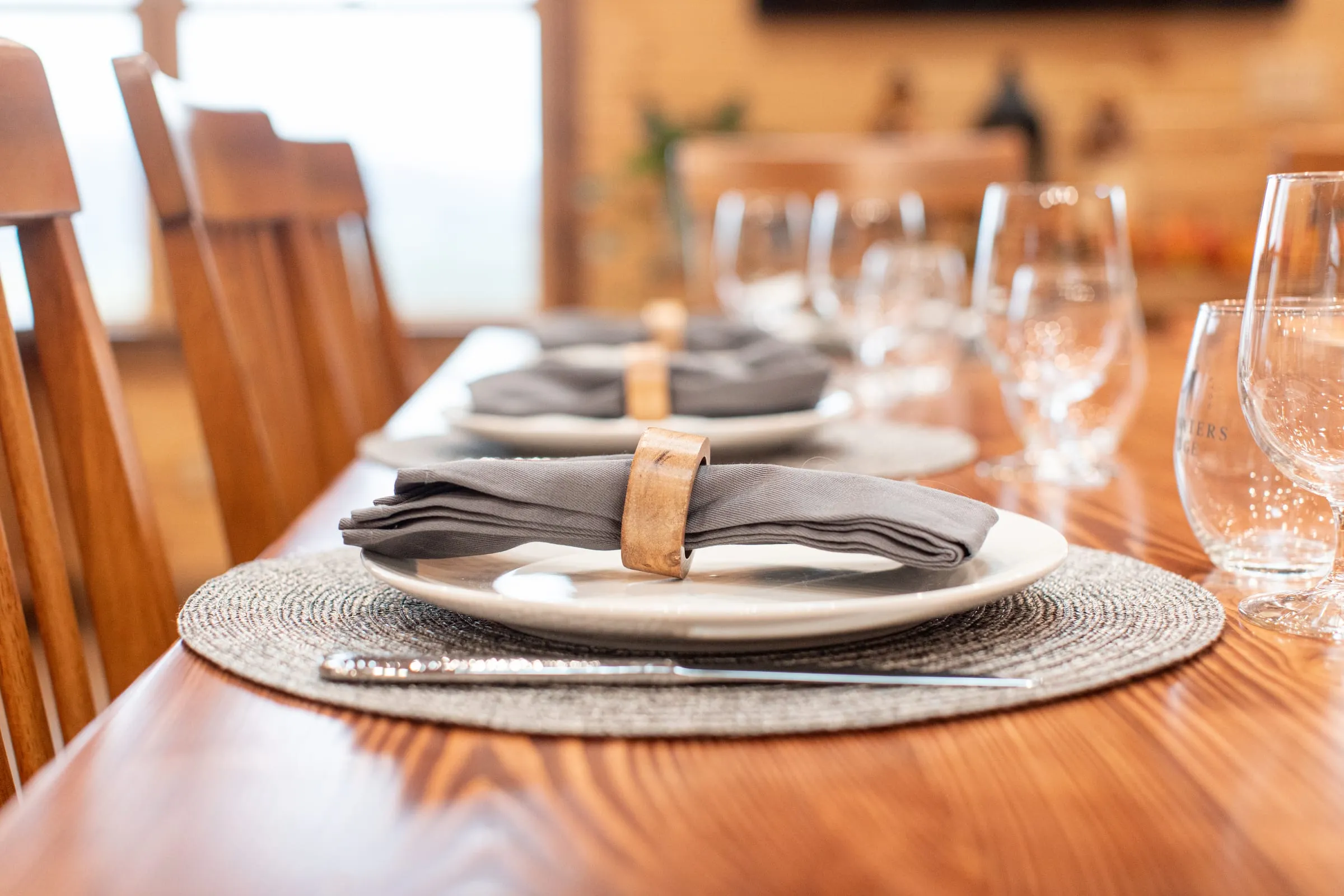 Close view of a reception place setting with linen napkin and glassware